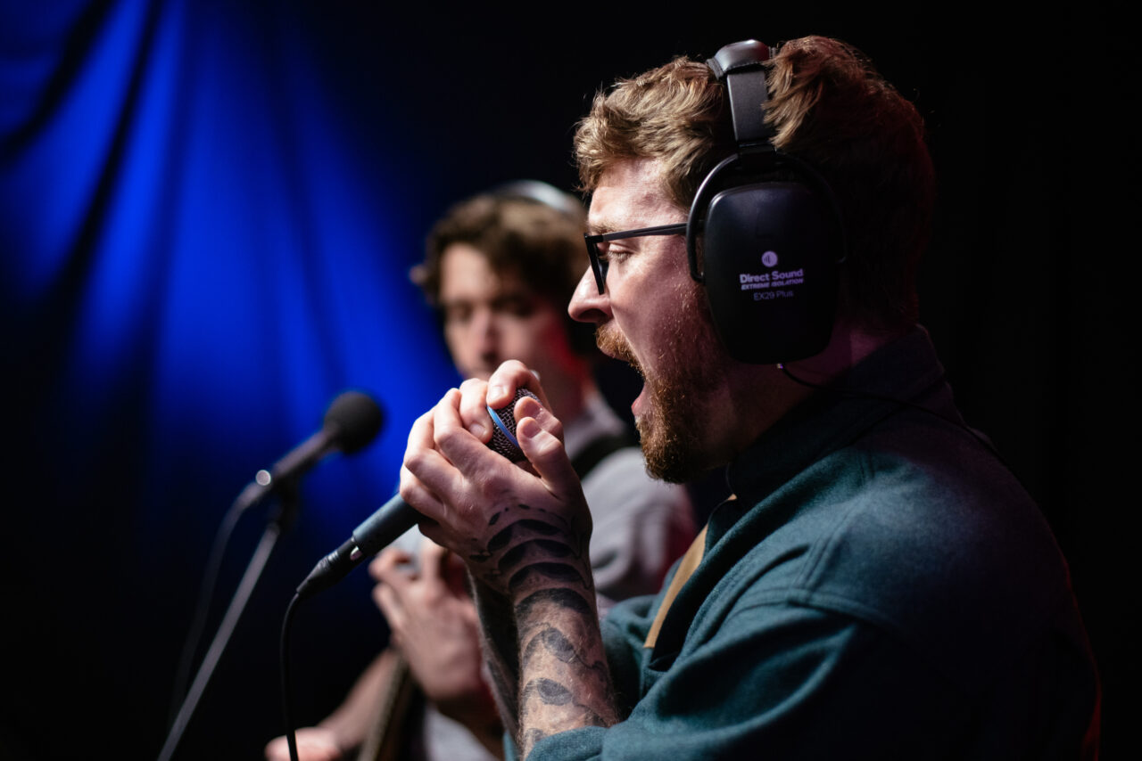 Lead singer of Making A Mockery singing into microphone.