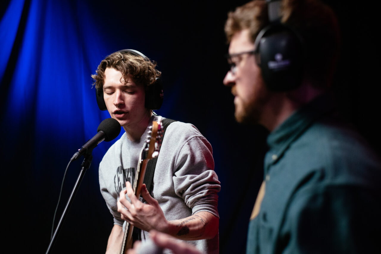 Singer in Making A Mockery singing into microphone.