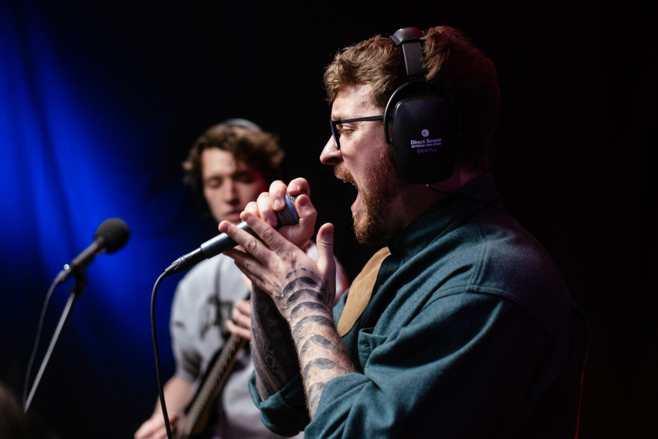 Lead singer of Making A Mockery singing into microphone.