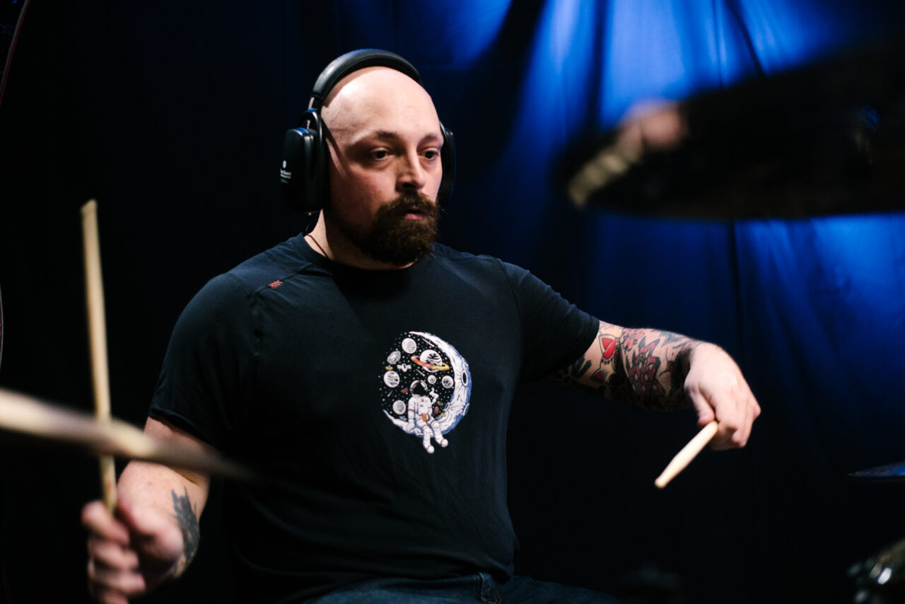 Drummer playing drums in Making A Mockery.
