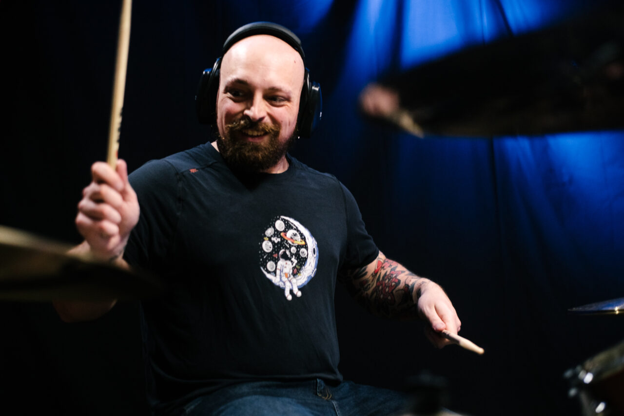 Drummer playing drums in Making A Mockery.