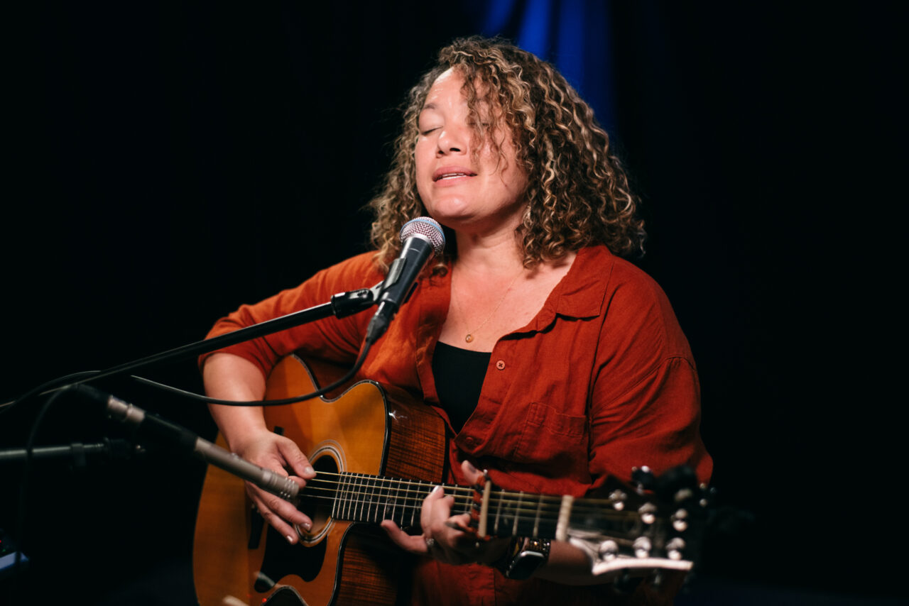 Singer/songwriter singing.