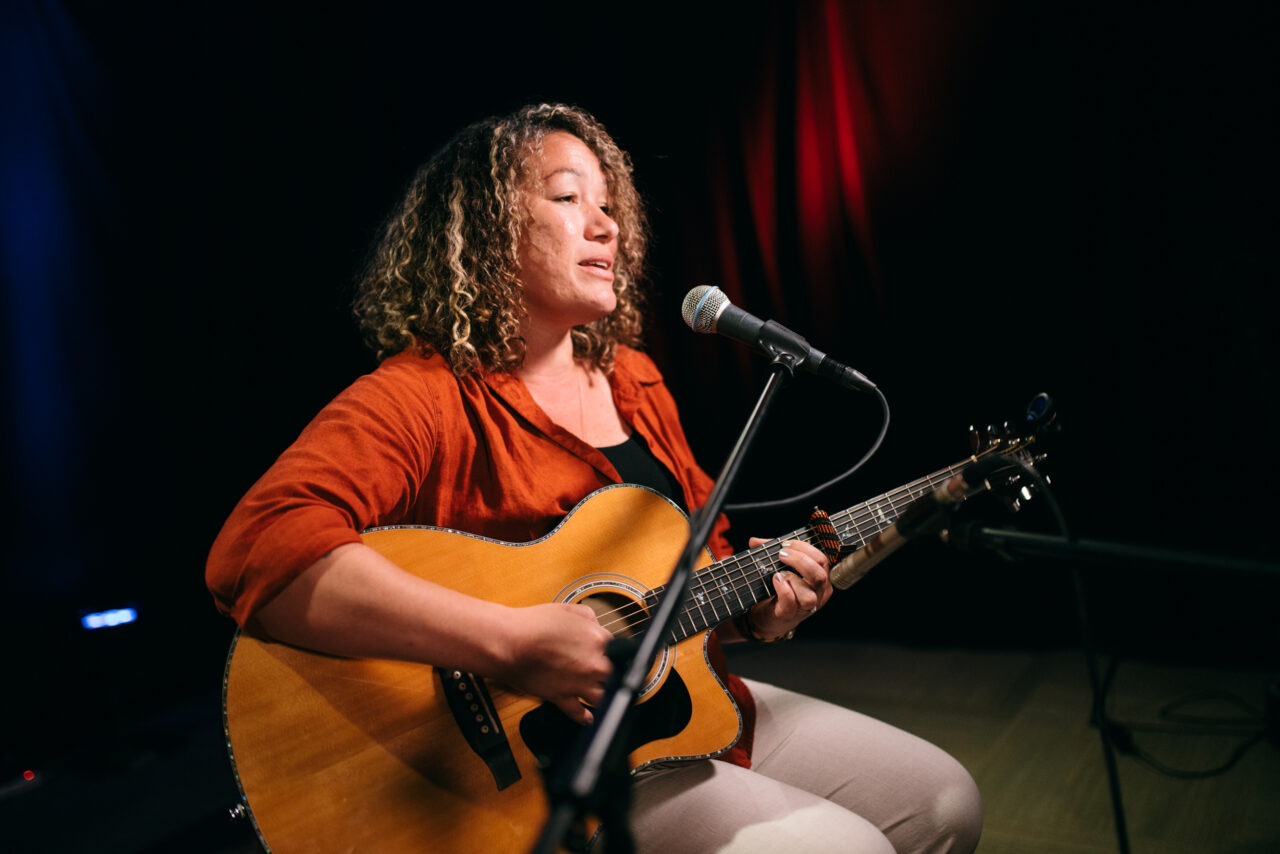 Singer/songwriter singing.