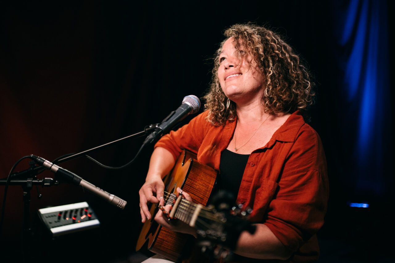 Singer/songwriter singing.