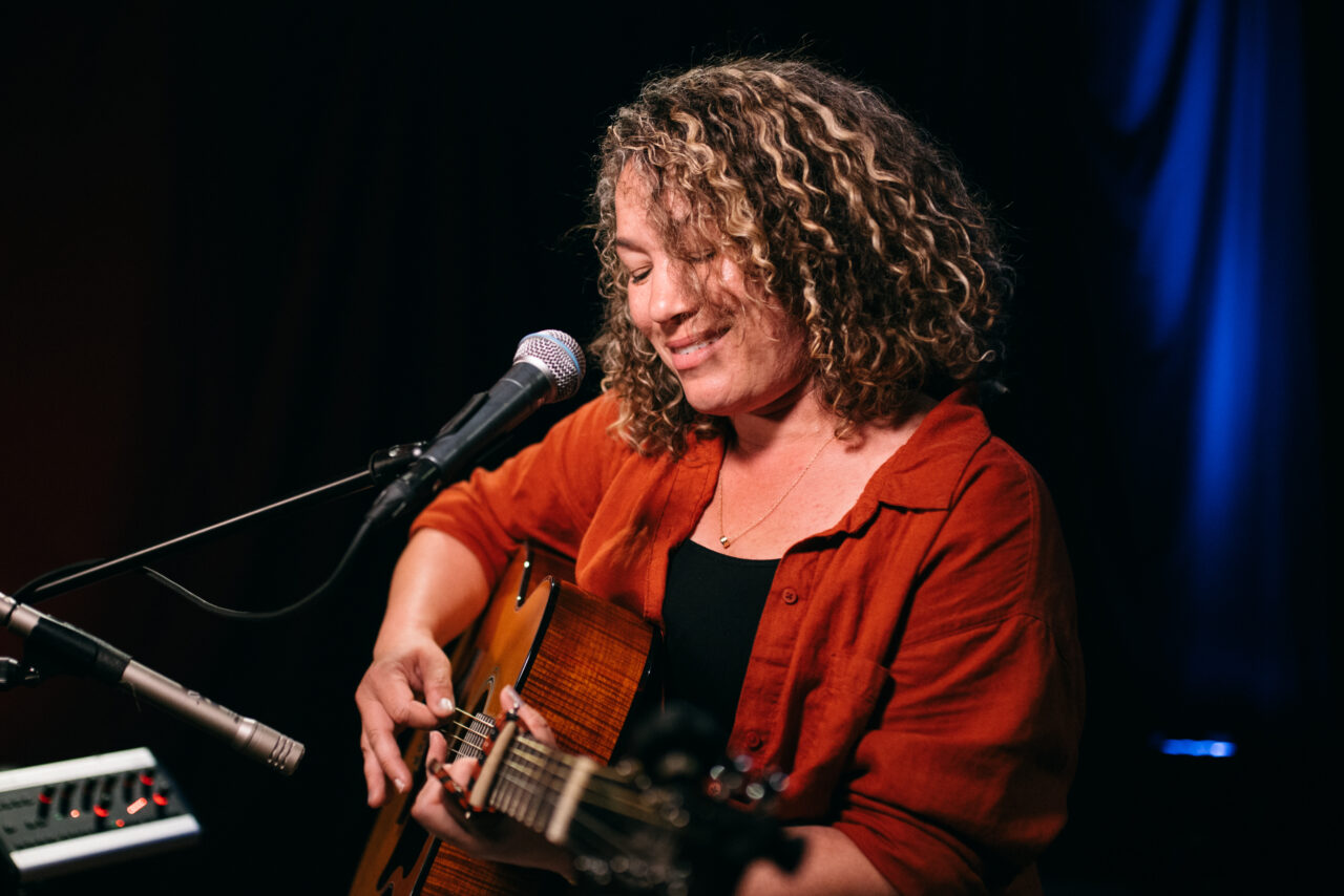 Singer/songwriter singing.