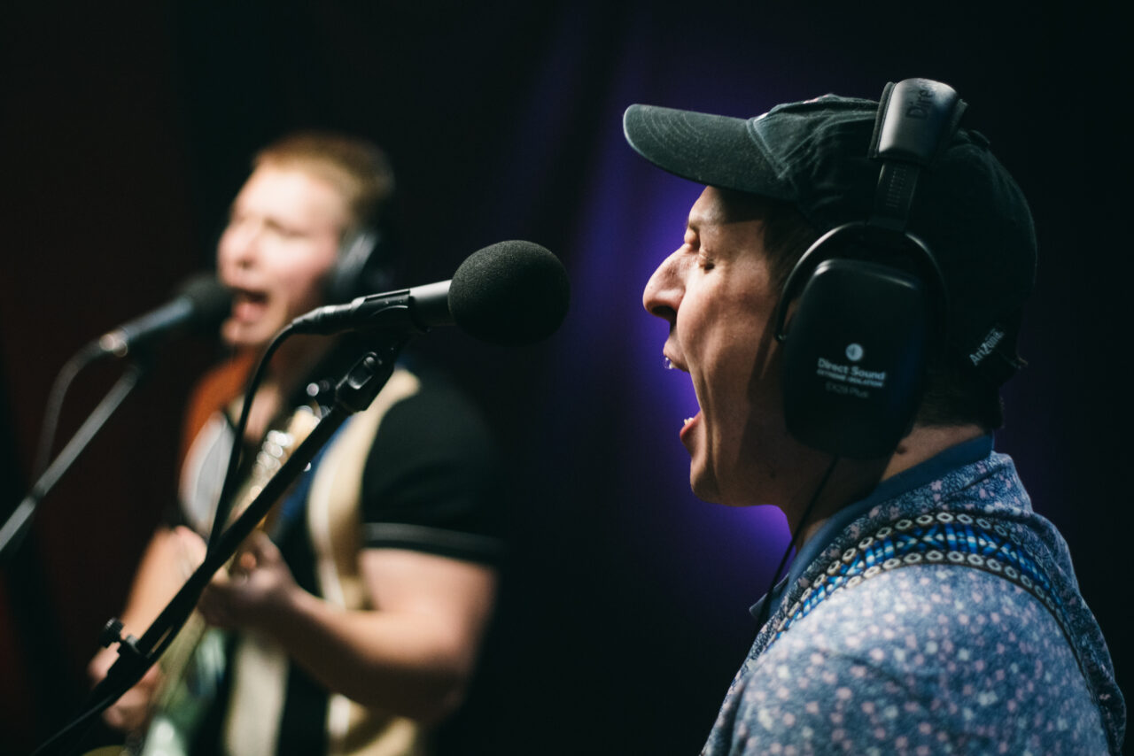 A person singing into a microphone.