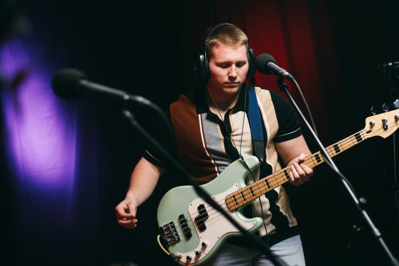 A person playing a bass guitar.