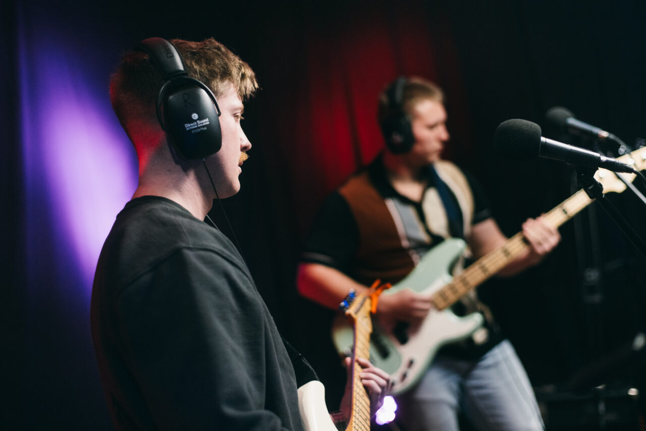 A guitars singing into a mic.