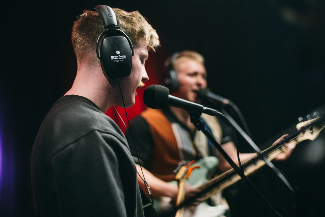 A guitars singing into a mic.