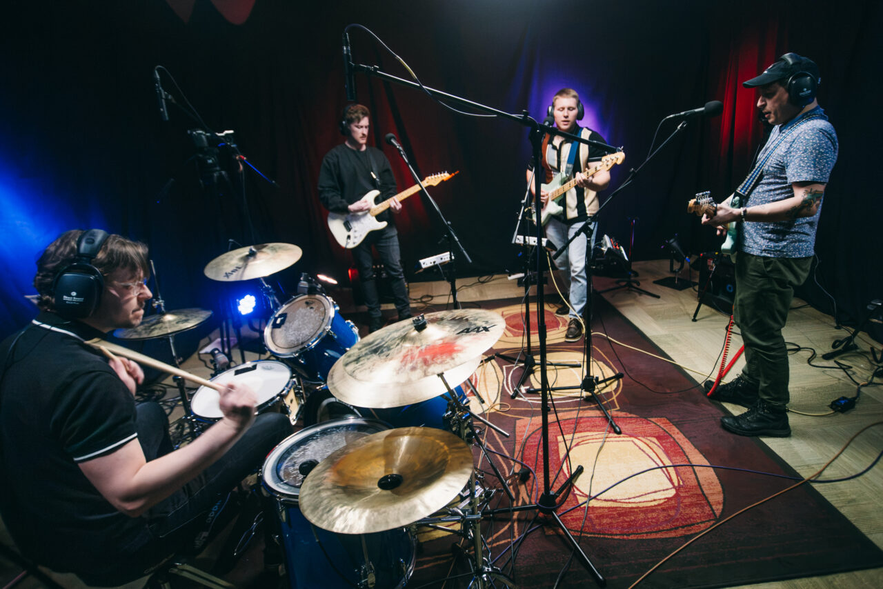 A band performing in a small room.