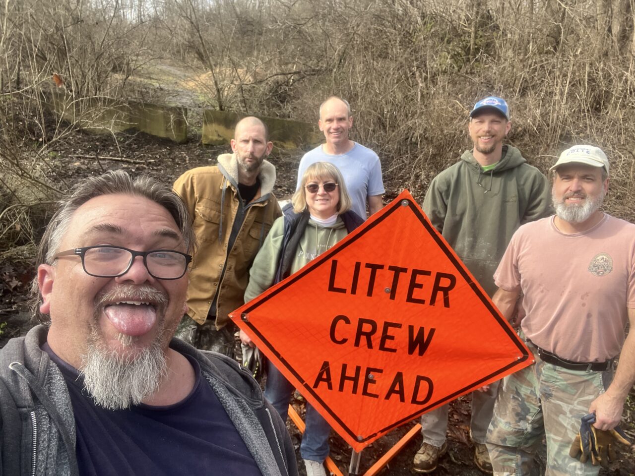 Todd Roy stands in front of a litter crew.