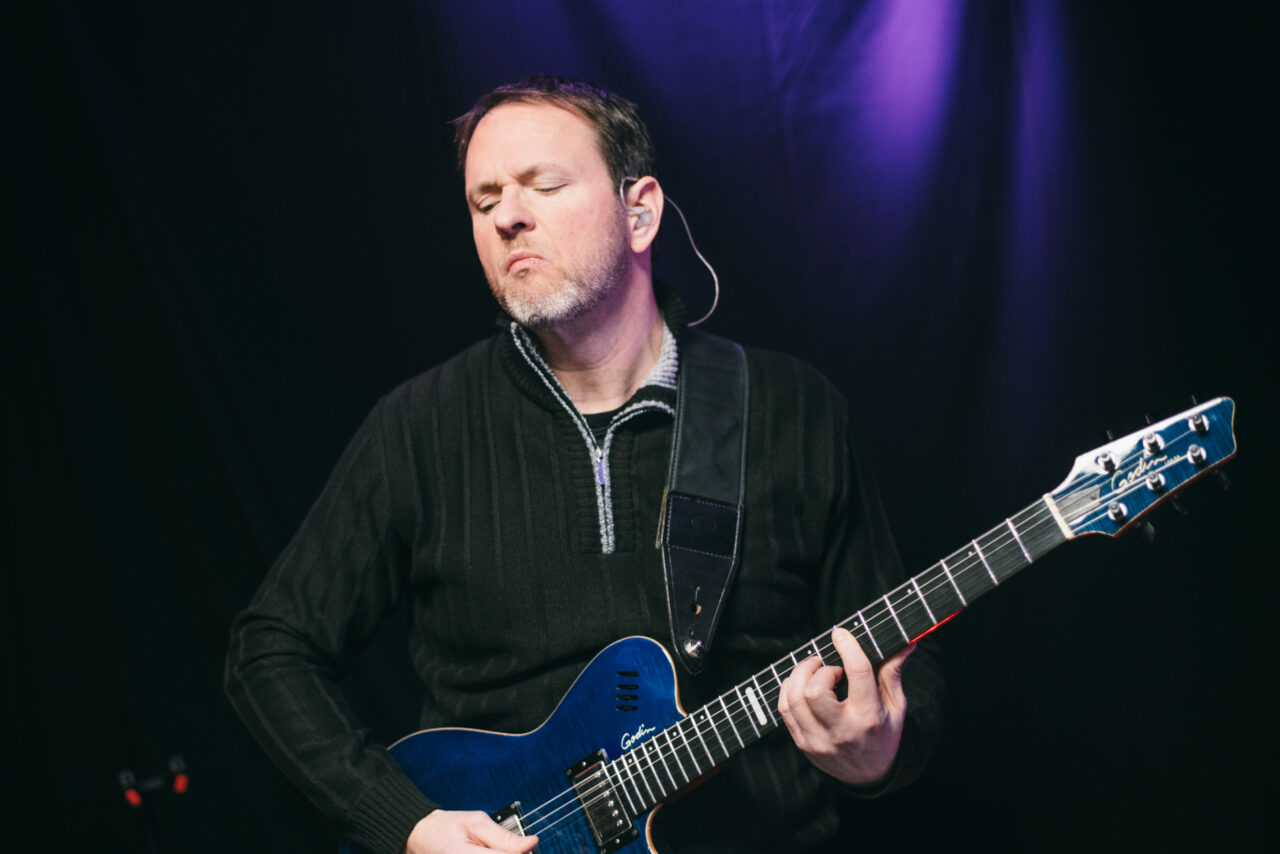 A man playing guitar.