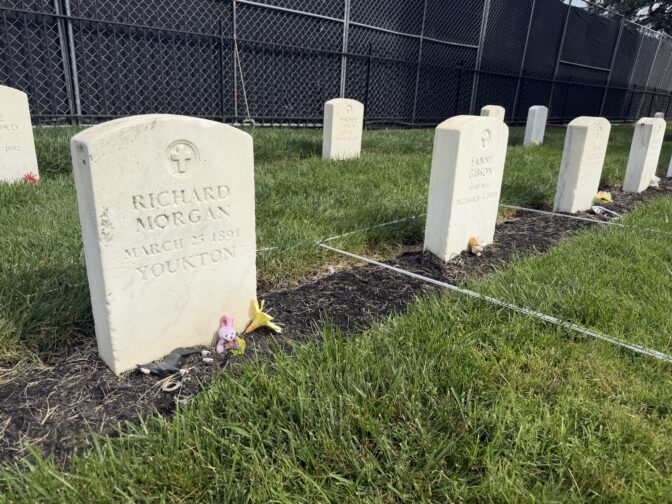 The graves of students who died while attending Carlisle Indian Industrial School are decorated with flowers and small stuff animals on Aug. 31, 2026.