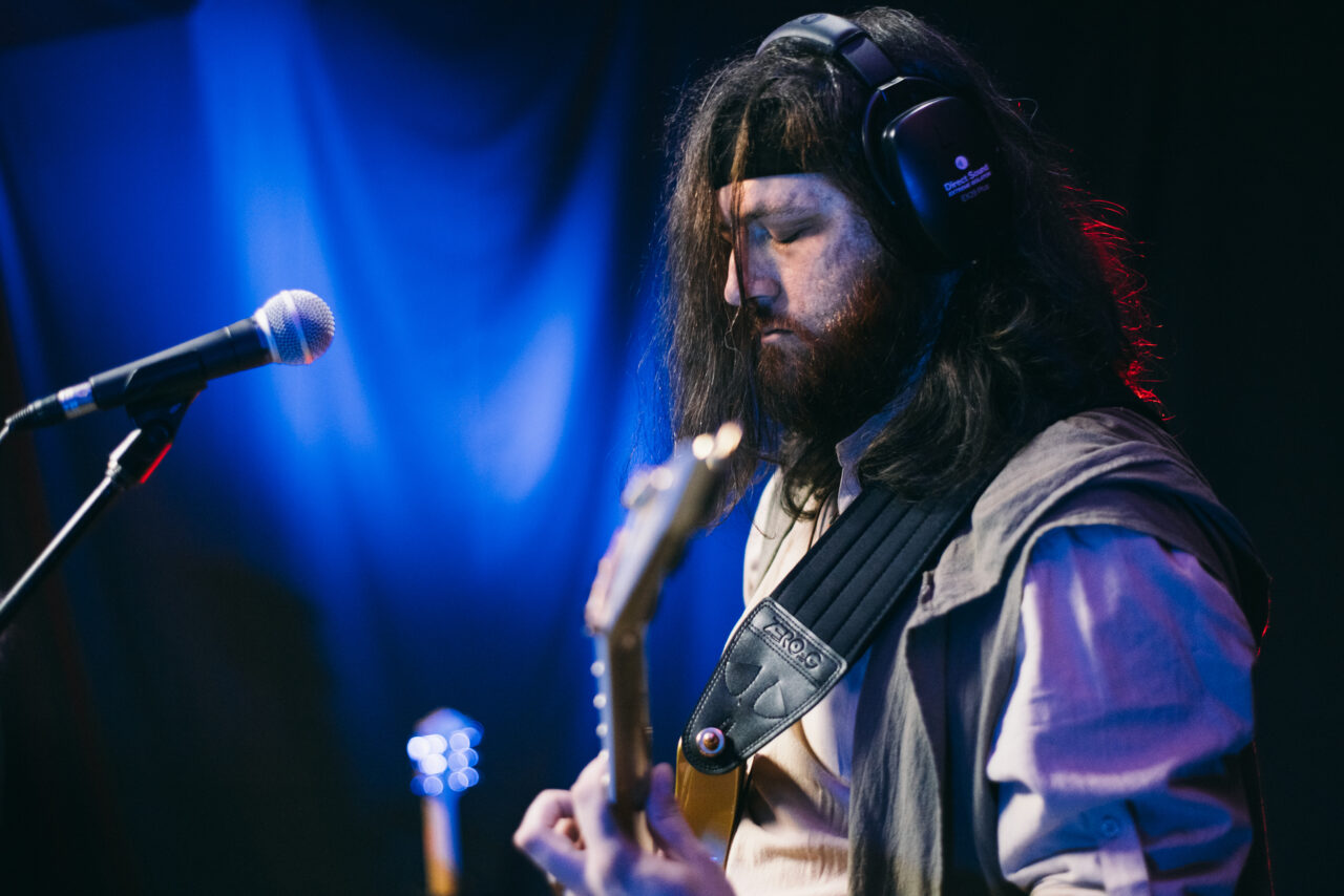 A man playing guitar.